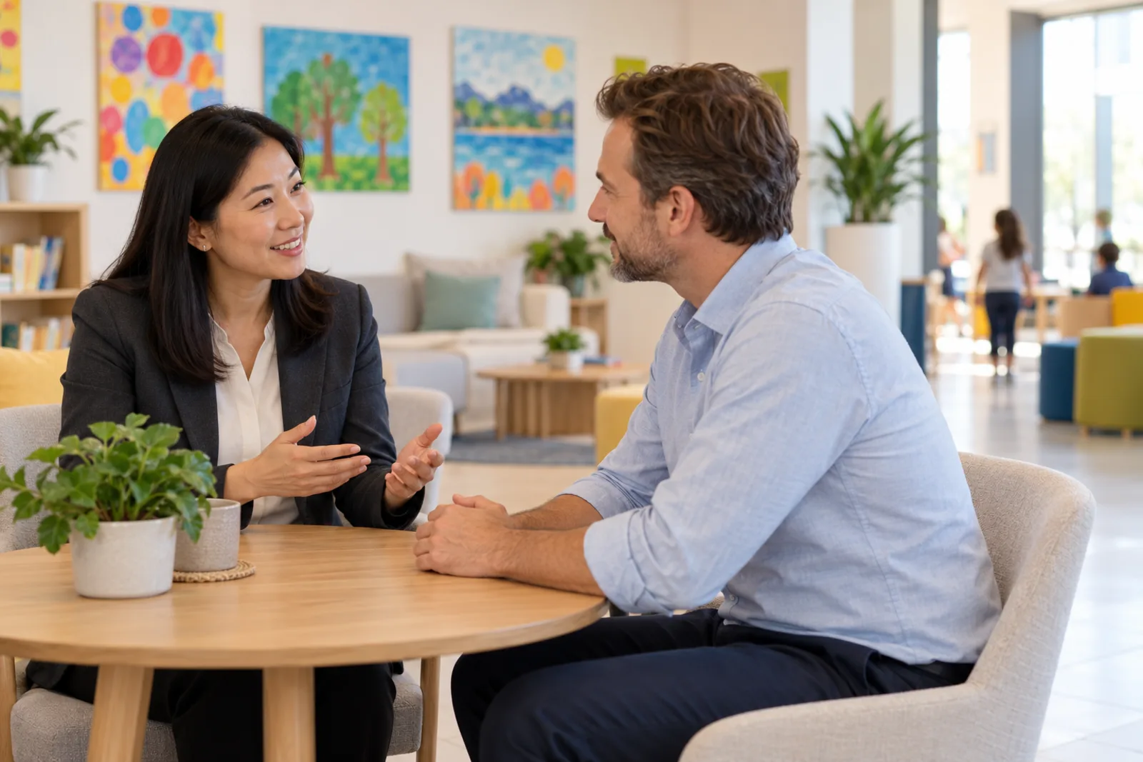 A school administrator meeting a parent in the school office